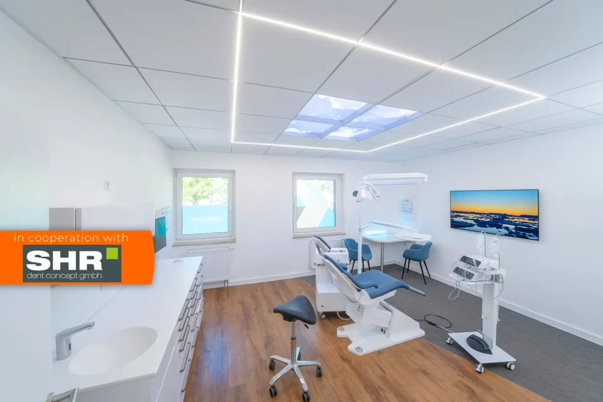 Dentled integrated LED ceiling panels in a contemporary implantology clinic treatment room in NRW.